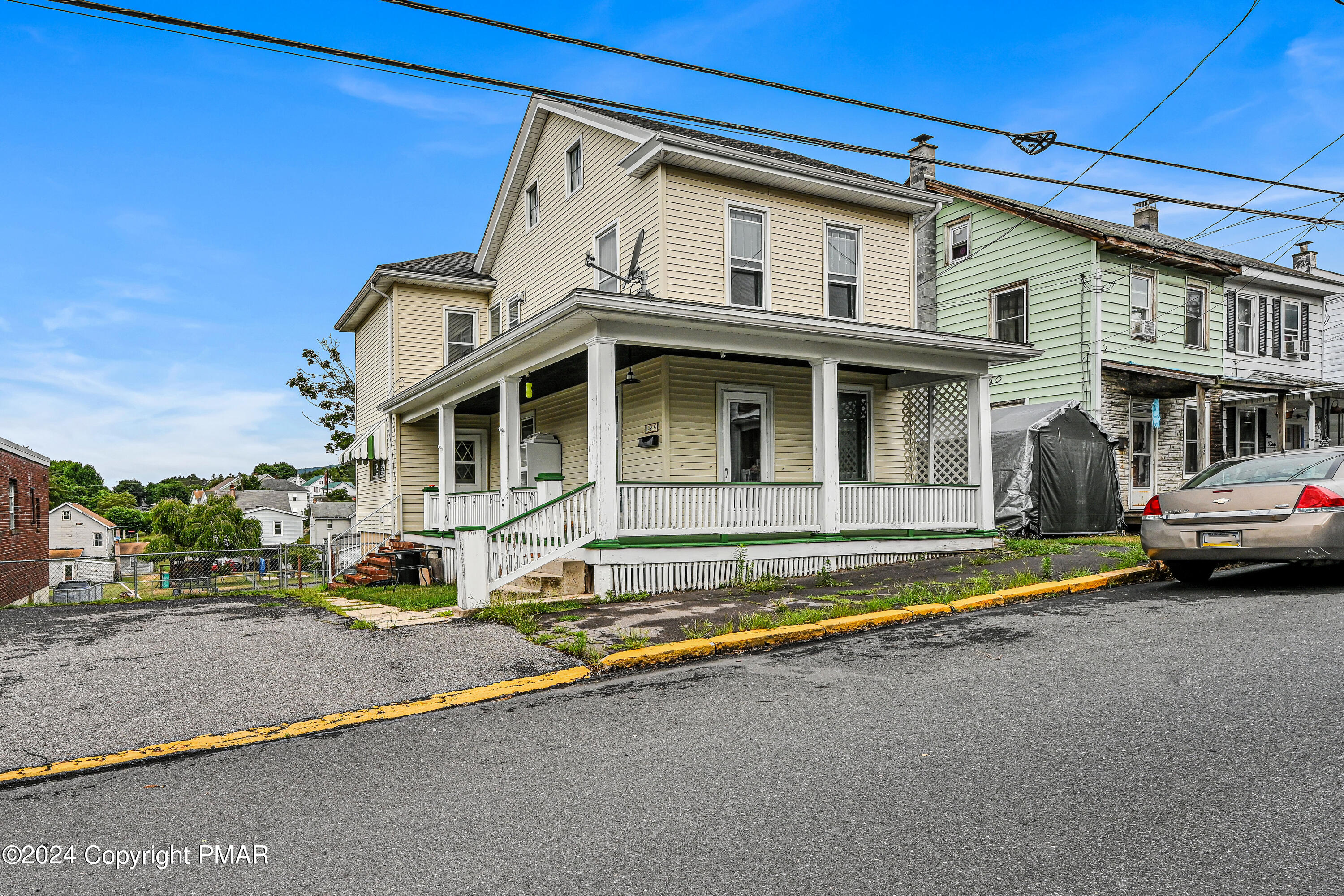 128 North West Street Williamstown, PA 17098 - Photo 2 of 23 a view of a white house with a large windows and a small yard