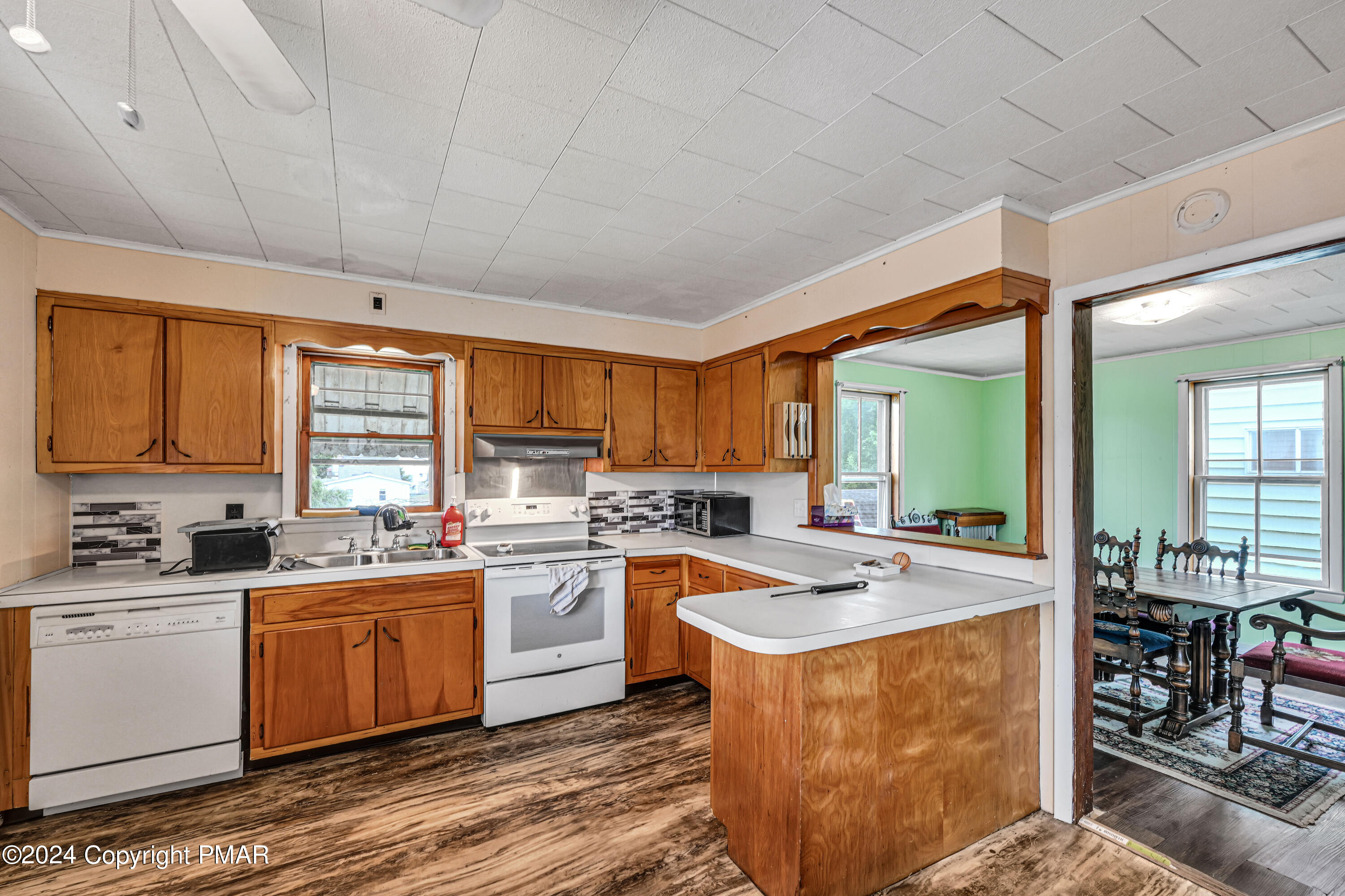 128 North West Street Williamstown, PA 17098 - Photo 8 of 23 a kitchen with stainless steel appliances granite countertop a stove a sink dishwasher and white cabinets with wooden floor