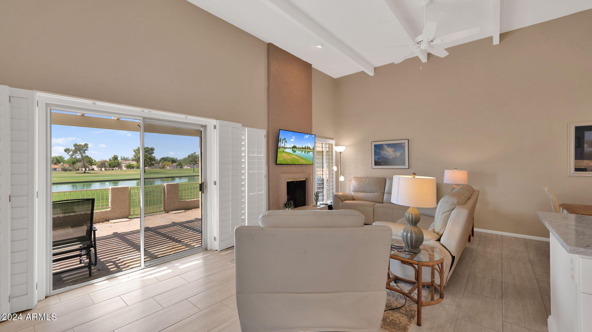 7819 East Vía Rio Scottsdale, AZ 85258 - Photo 12 of 42 a living room with fireplace furniture and a floor to ceiling window