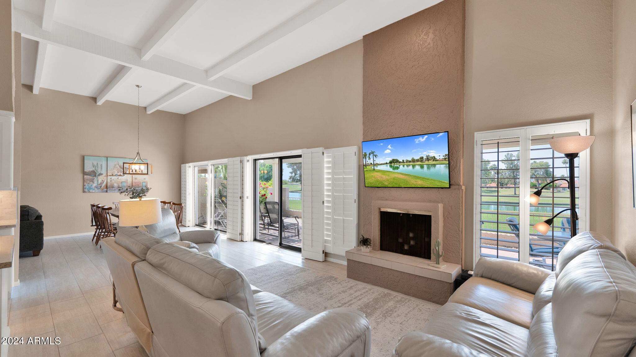 7819 East Vía Rio Scottsdale, AZ 85258 - Photo 13 of 42 a living room with furniture flat screen tv and a fireplace