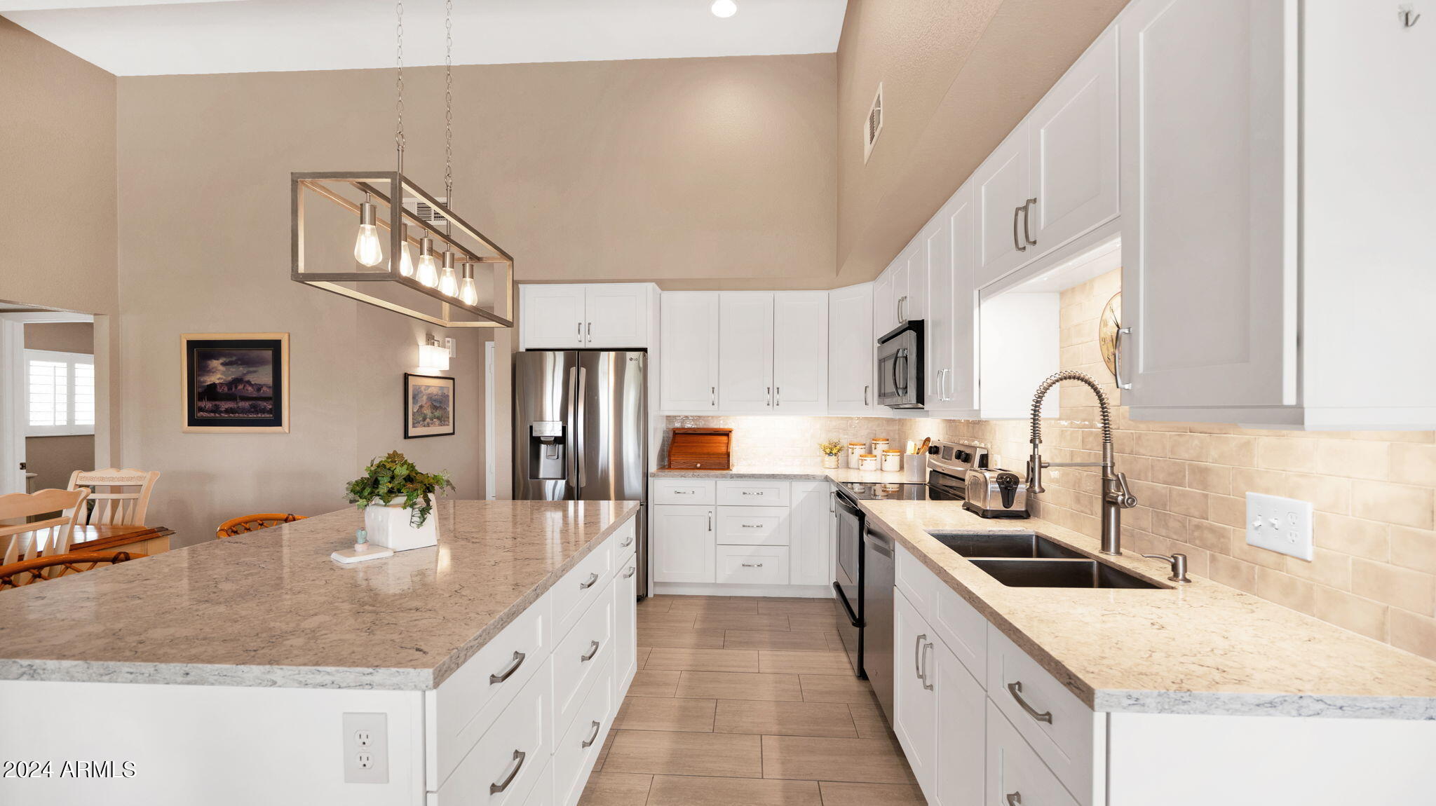 7819 East Vía Rio Scottsdale, AZ 85258 - Photo 15 of 42 a large kitchen with stainless steel appliances granite countertop a sink stove and cabinets