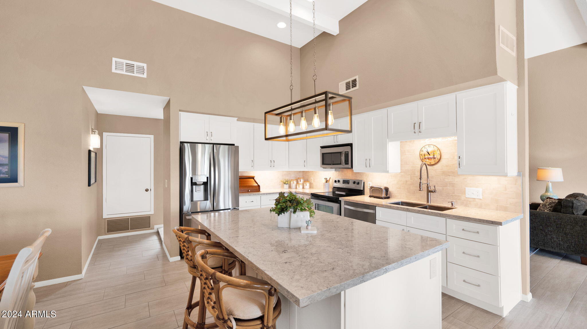 7819 East Vía Rio Scottsdale, AZ 85258 - Photo 16 of 42 a kitchen with stainless steel appliances kitchen island granite countertop a sink and cabinets