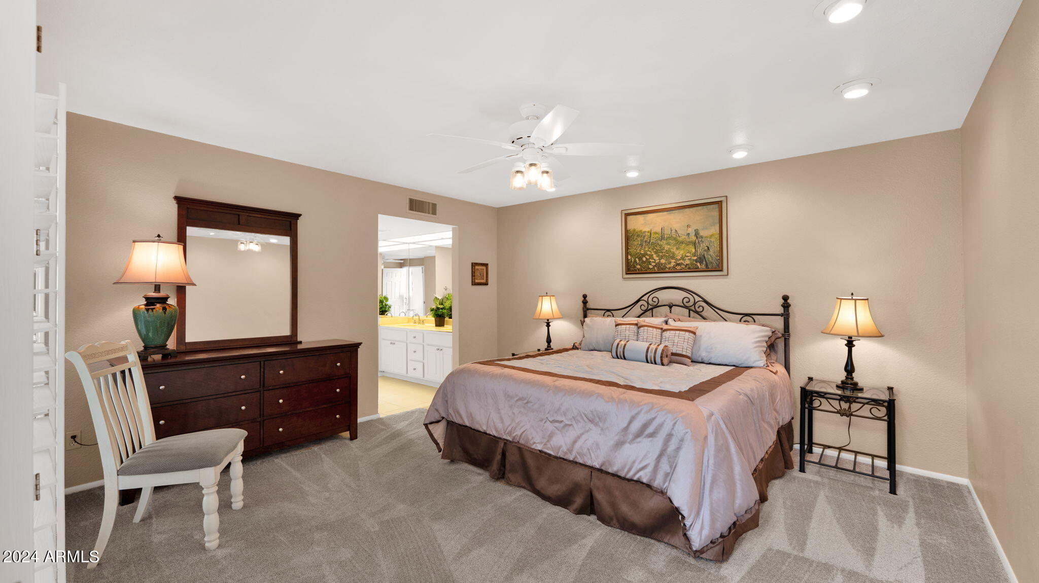 7819 East Vía Rio Scottsdale, AZ 85258 - Photo 22 of 42 a bedroom with a bed and a lamp on dresser