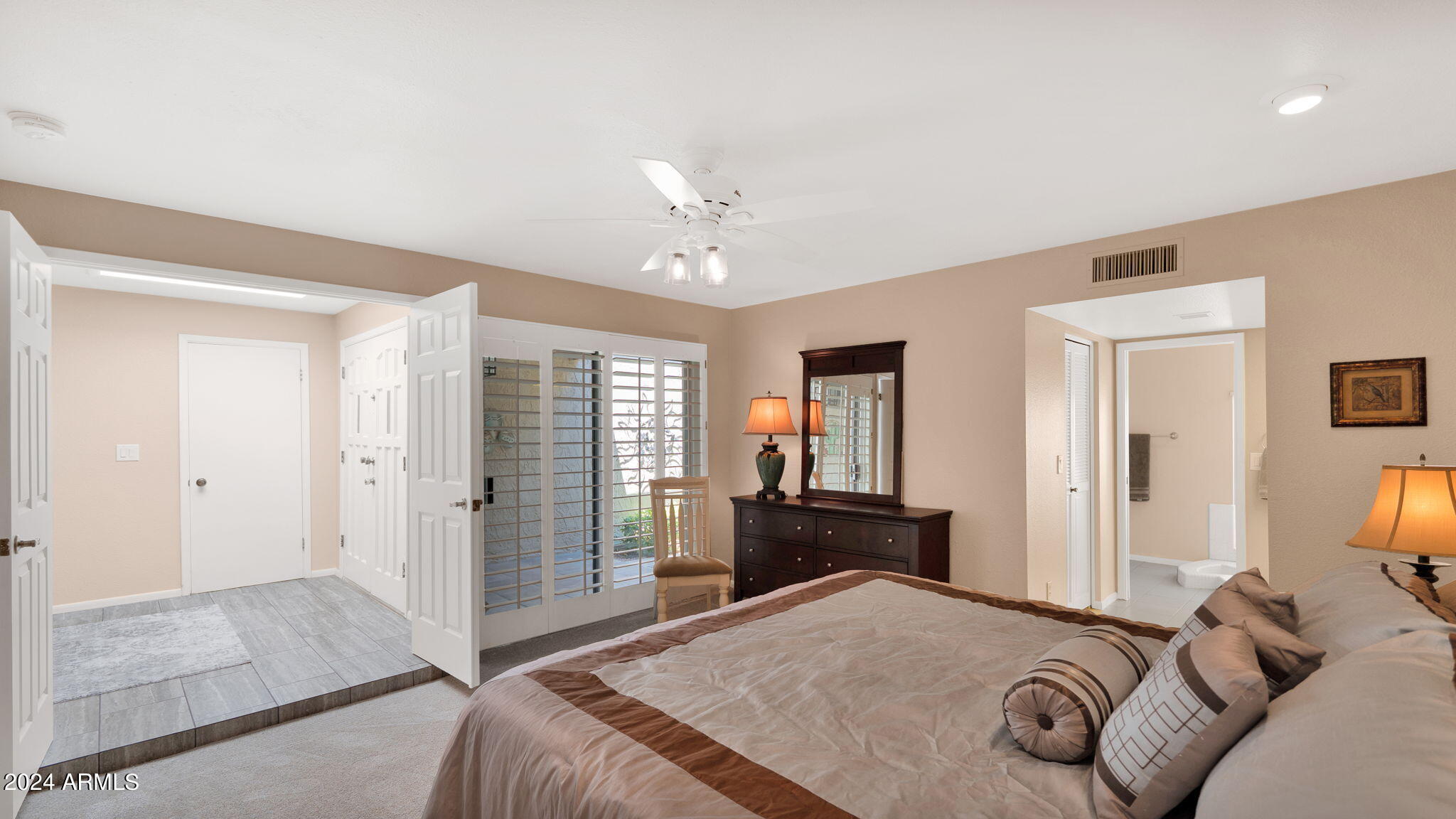 7819 East Vía Rio Scottsdale, AZ 85258 - Photo 24 of 42 a bedroom with a bed dresser and a window