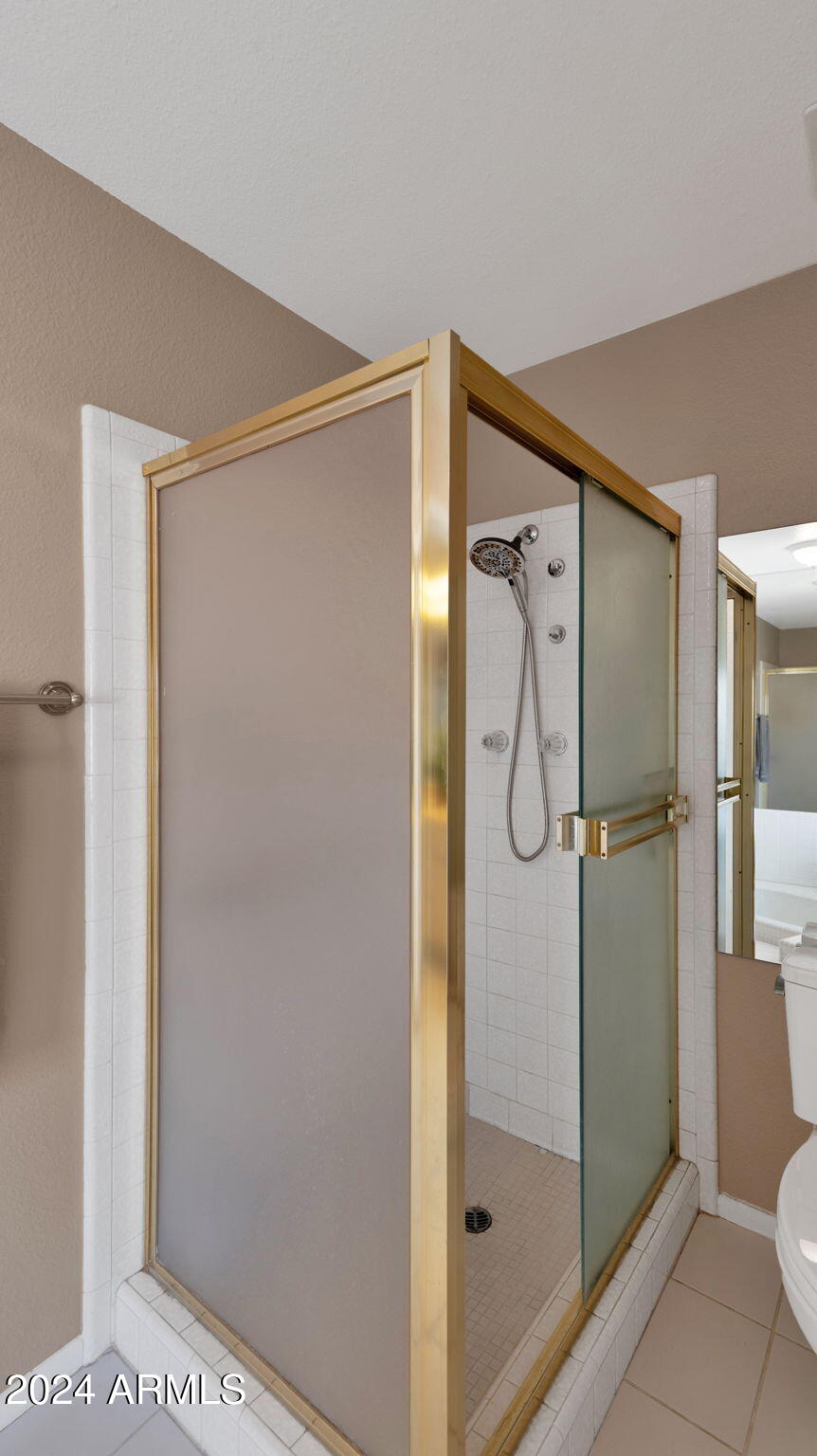 7819 East Vía Rio Scottsdale, AZ 85258 - Photo 27 of 42 a bathroom with a glass shower door and a sink