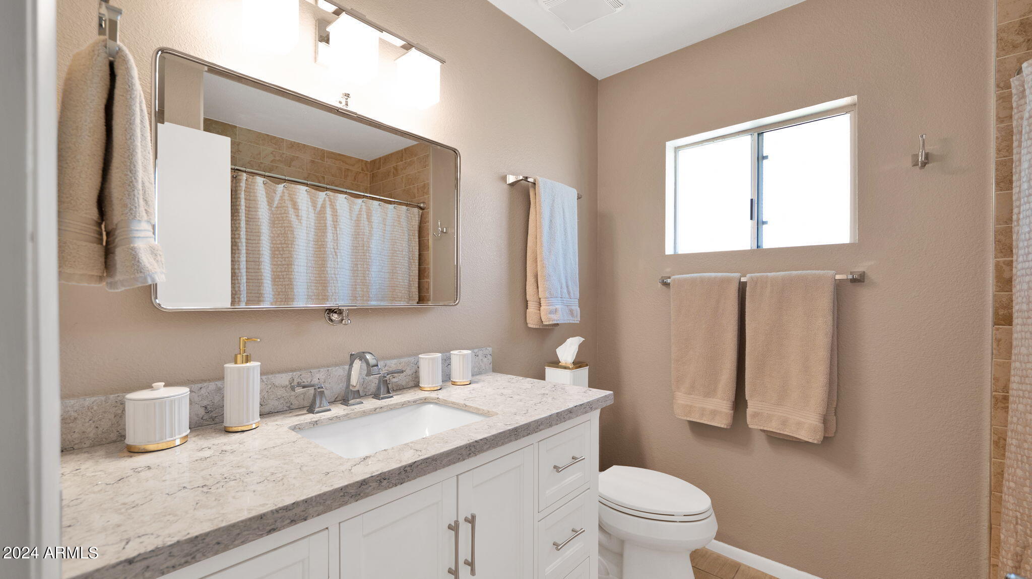7819 East Vía Rio Scottsdale, AZ 85258 - Photo 30 of 42 a bathroom with a granite countertop sink toilet and mirror