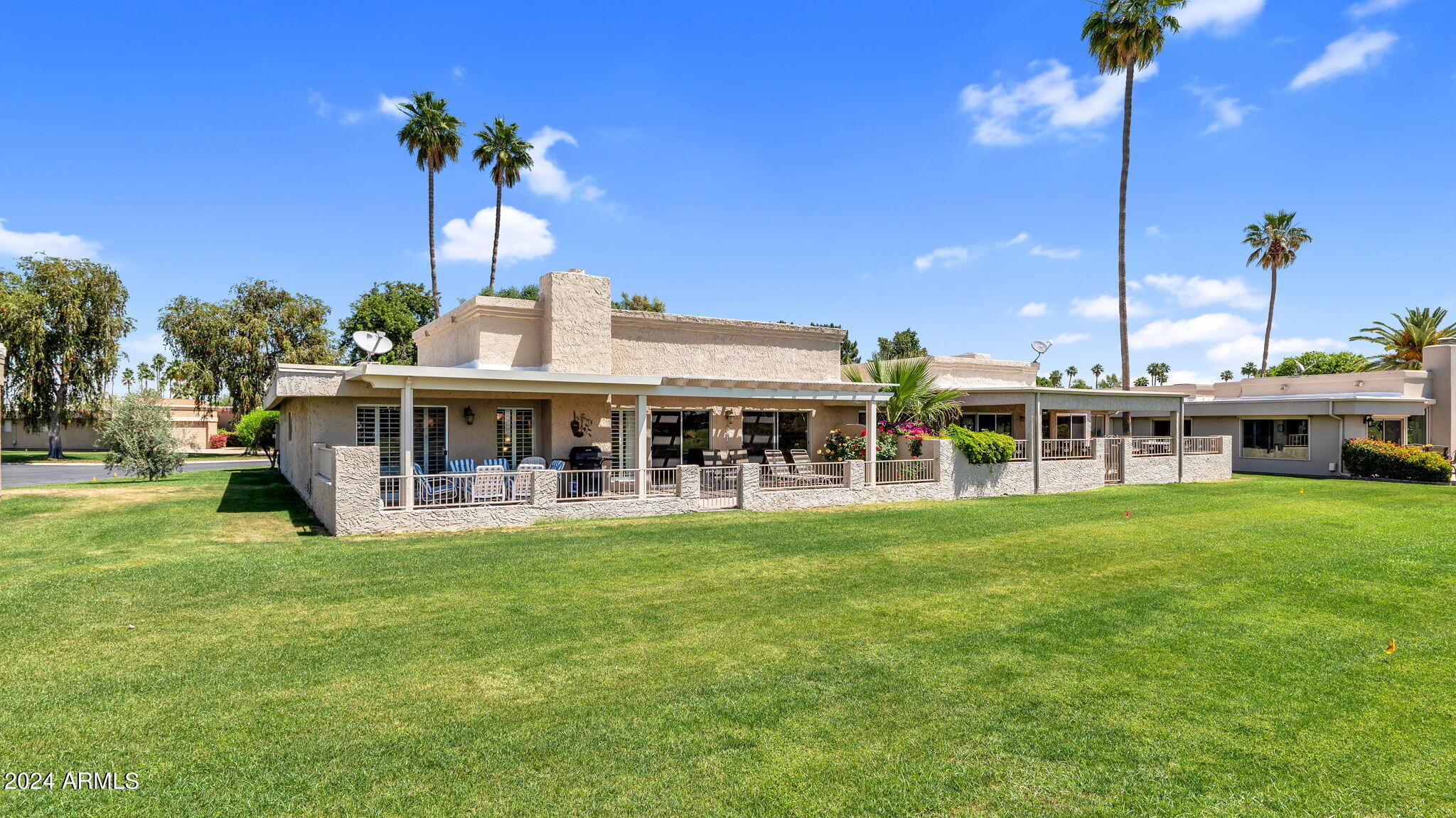 7819 East Vía Rio Scottsdale, AZ 85258 - Photo 33 of 42 a view of a house with a big yard and potted plants