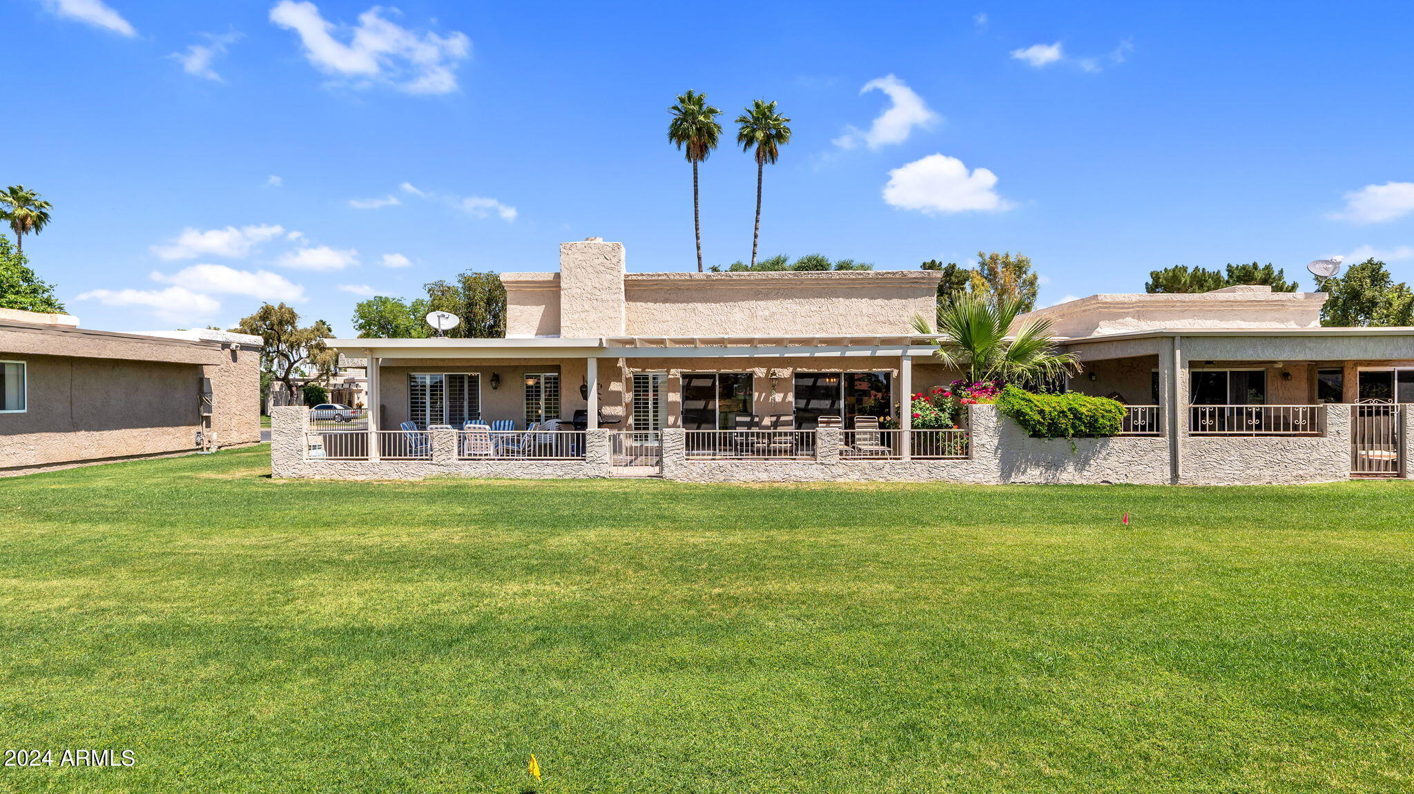 7819 East Vía Rio Scottsdale, AZ 85258 - Photo 34 of 42 a front view of a house with a garden