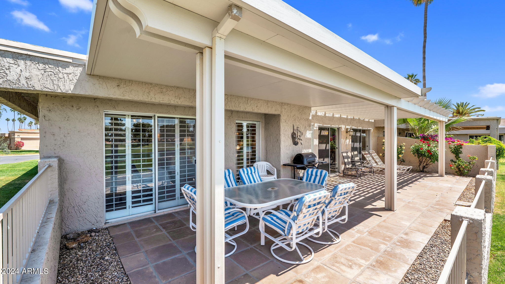 7819 East Vía Rio Scottsdale, AZ 85258 - Photo 37 of 42 a view of a patio with table and chairs and potted plants