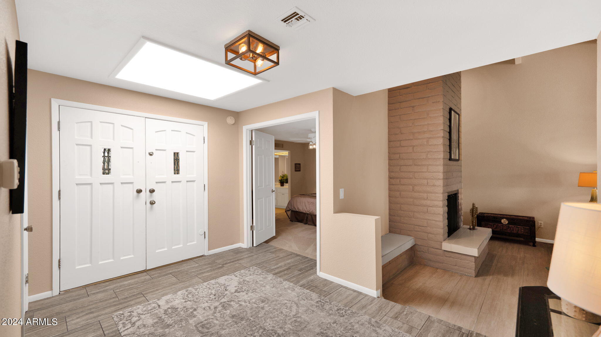 7819 East Vía Rio Scottsdale, AZ 85258 - Photo 4 of 42 a view of a hallway with couch and cabinet