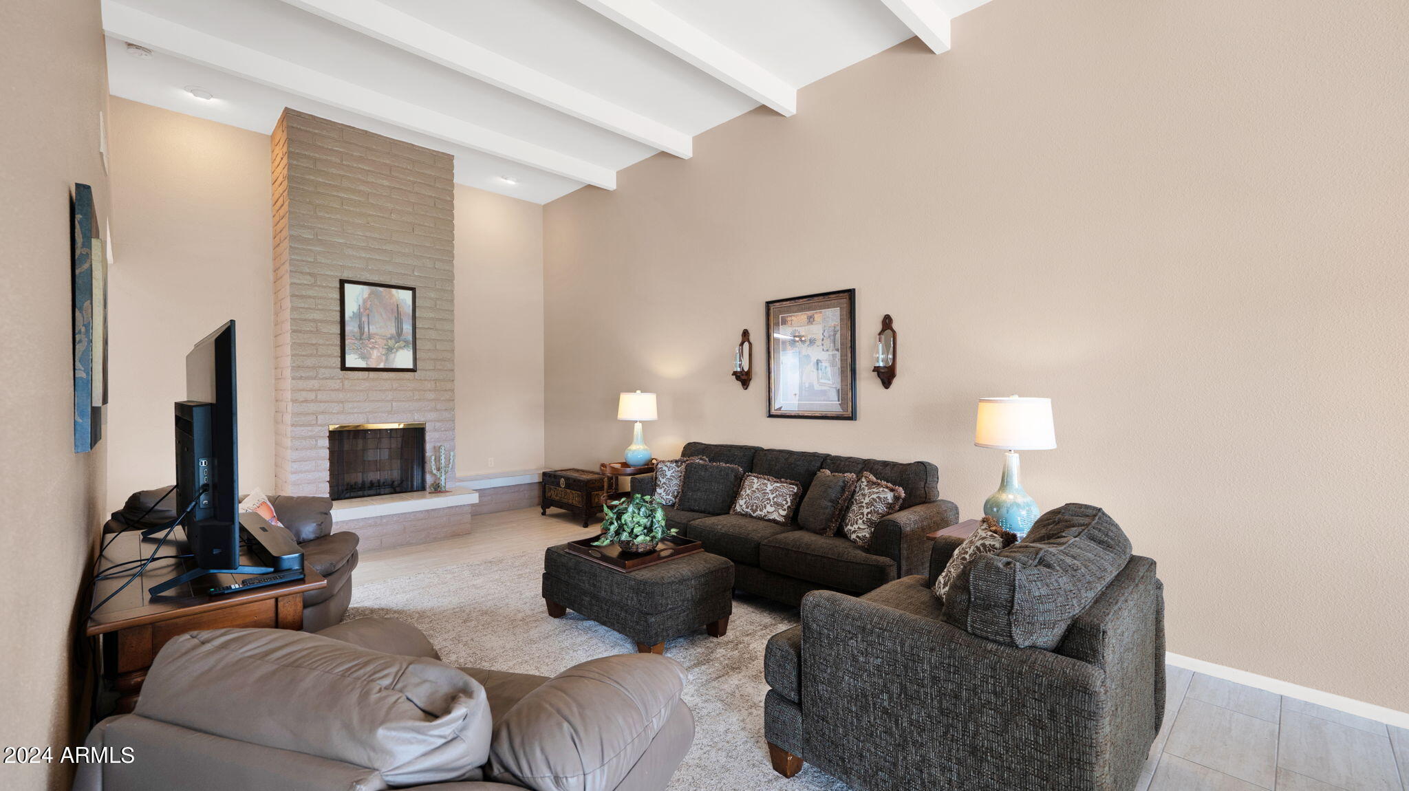 7819 East Vía Rio Scottsdale, AZ 85258 - Photo 8 of 42 a living room with furniture a fireplace and a flat screen tv