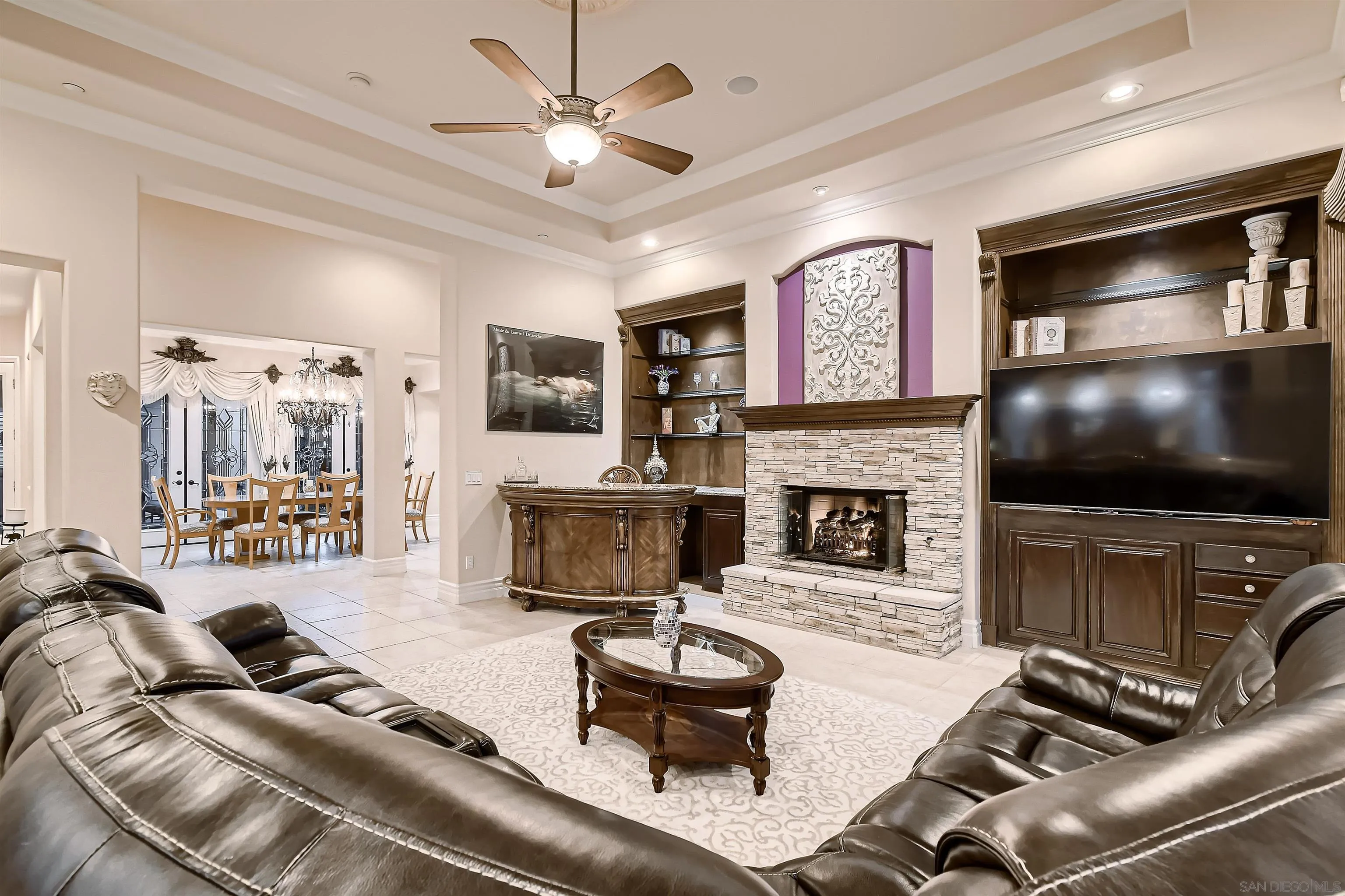 3349 Mendenaro Court Fallbrook, CA 92028 - Photo 12 of 31 a living room with furniture a flat screen tv and a fireplace