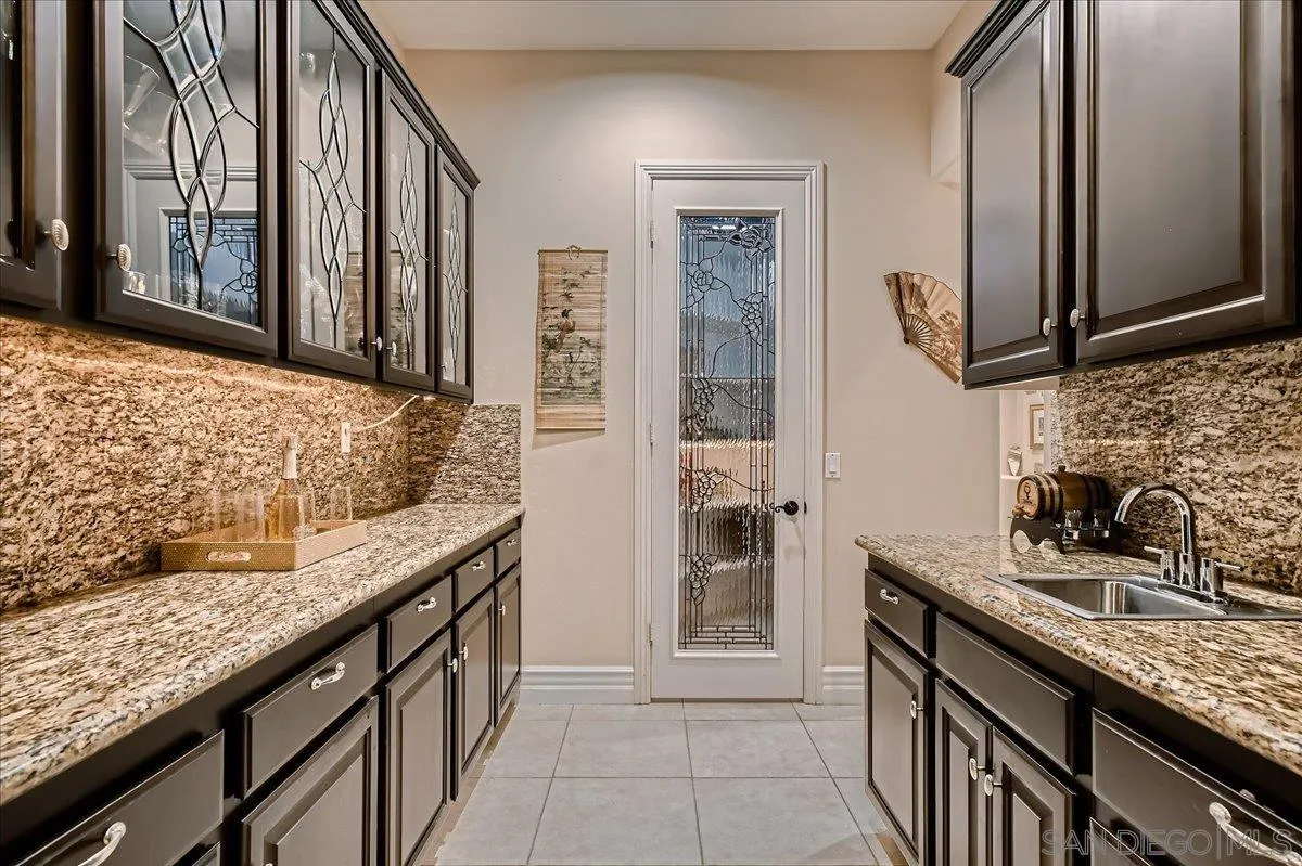 3349 Mendenaro Court Fallbrook, CA 92028 - Photo 15 of 34 a bathroom with a granite countertop sink and a mirror