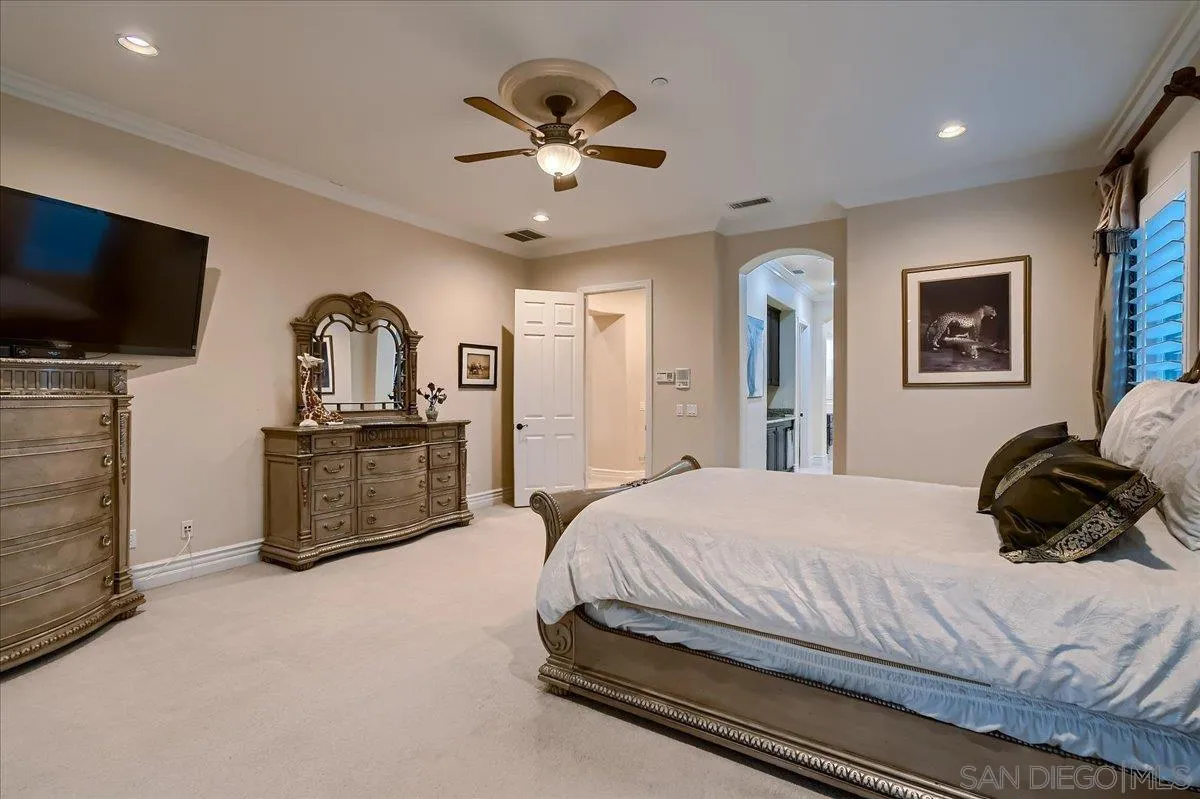 3349 Mendenaro Court Fallbrook, CA 92028 - Photo 23 of 34 a bedroom with a bed a flat screen tv and a couch