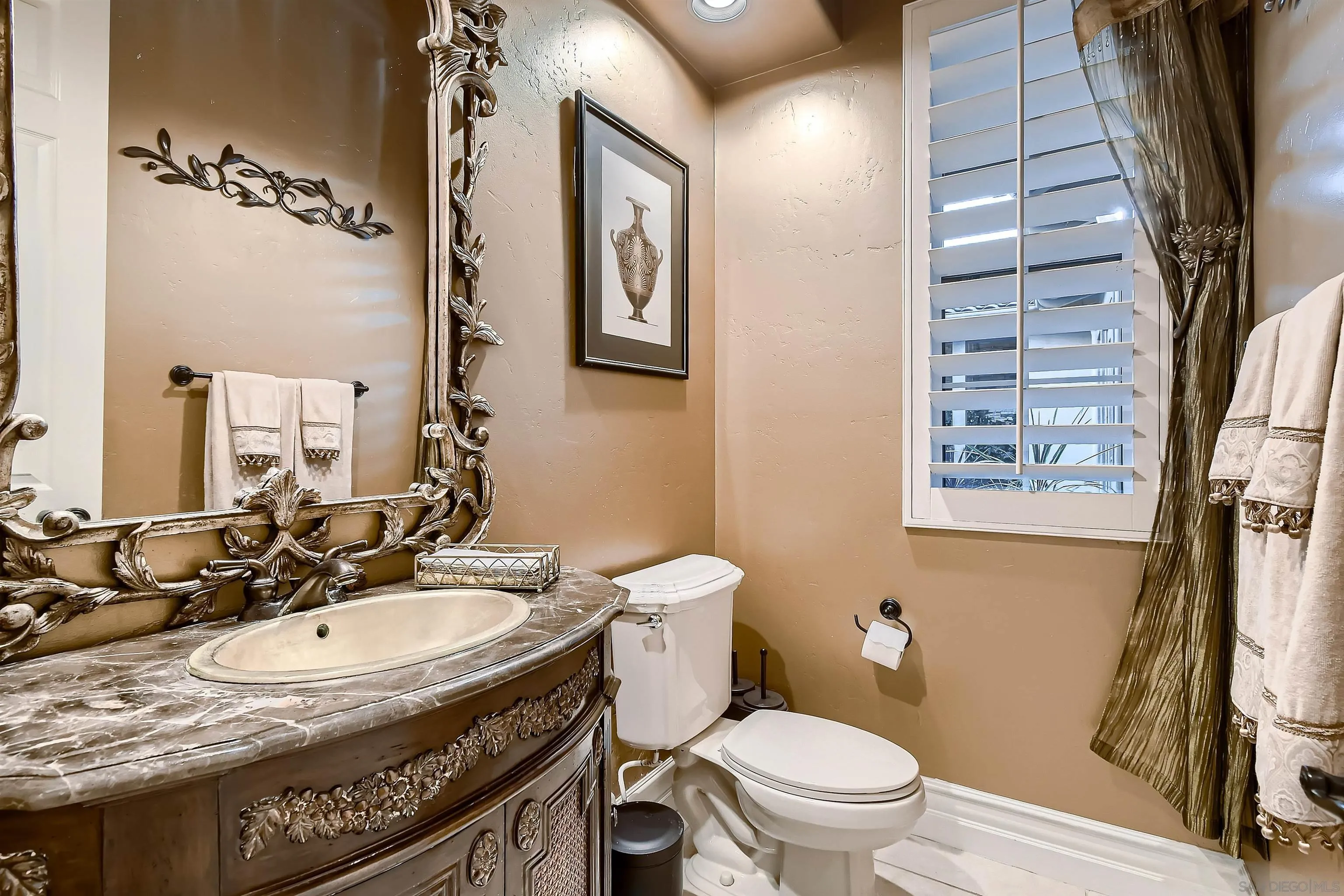 3349 Mendenaro Court Fallbrook, CA 92028 - Photo 23 of 31 a bathroom with a sink a toilet a mirror and shower