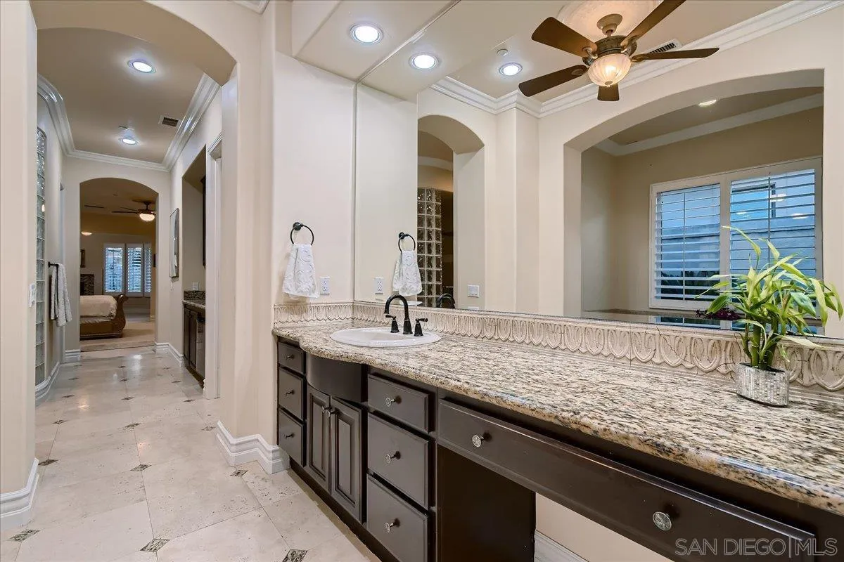 3349 Mendenaro Court Fallbrook, CA 92028 - Photo 24 of 34 a bathroom with a granite countertop sink and a mirror