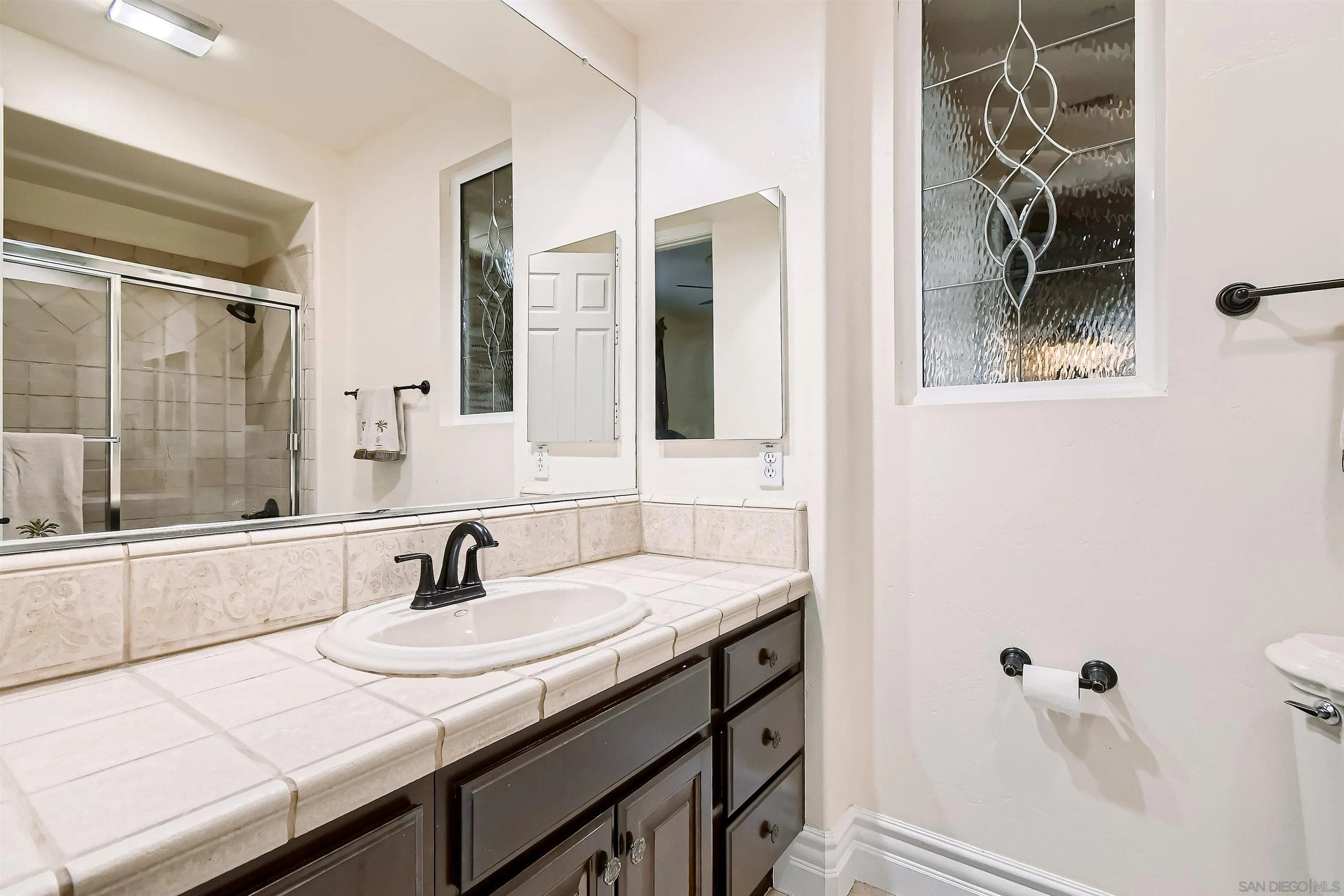 3349 Mendenaro Court Fallbrook, CA 92028 - Photo 26 of 31 a bathroom with a granite countertop sink and a mirror