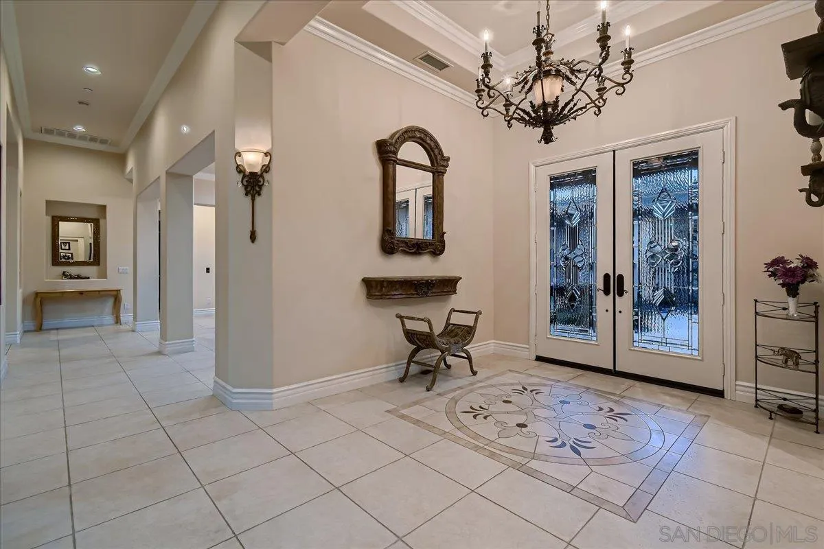 3349 Mendenaro Court Fallbrook, CA 92028 - Photo 7 of 34 a view of a hallway with wooden floor and glass door
