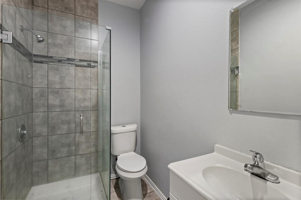 1556 John Wayne Road Kaufman, TX 75142 - Photo 17 of 33 a bathroom with a sink toilet and shower