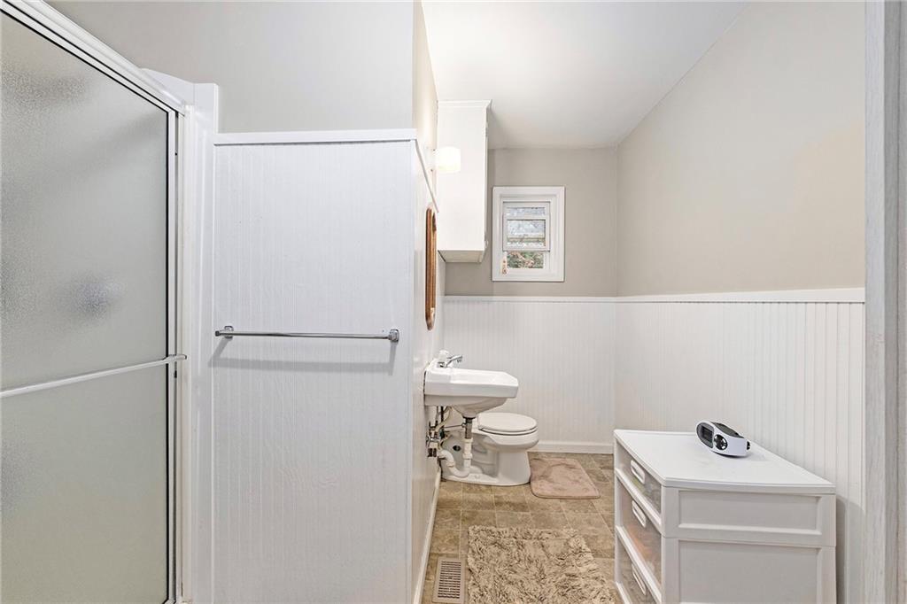 1246 Duncan Bridge Road Cornelia, GA 30531 - Photo 12 of 21 a bathroom with a sink a toilet and a shower