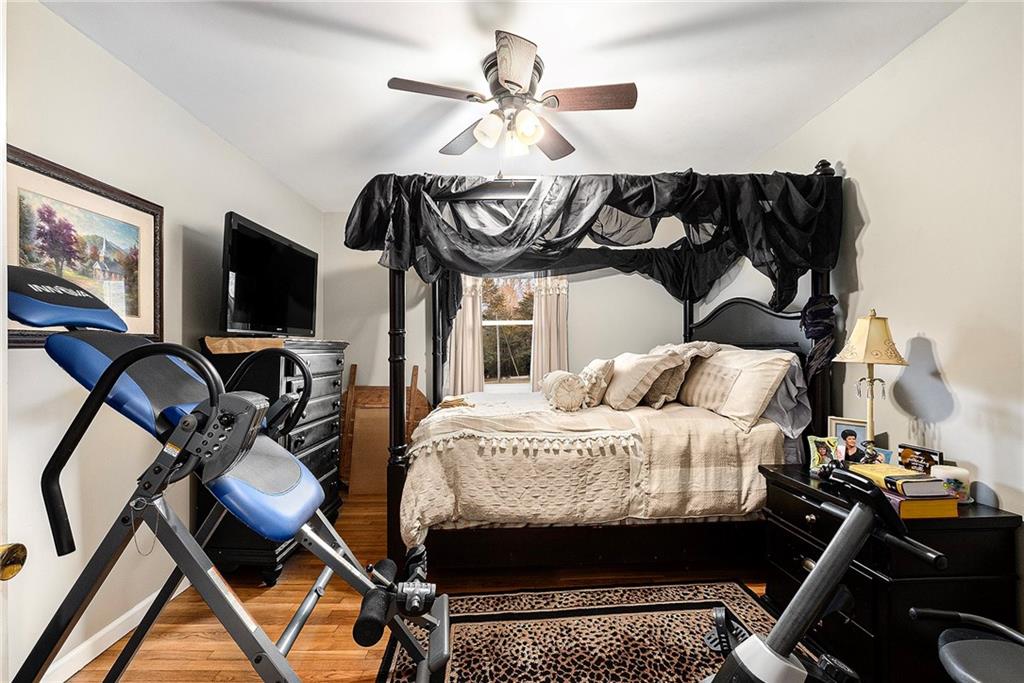 1246 Duncan Bridge Road Cornelia, GA 30531 - Photo 13 of 21 a bedroom with a bed and a chandelier