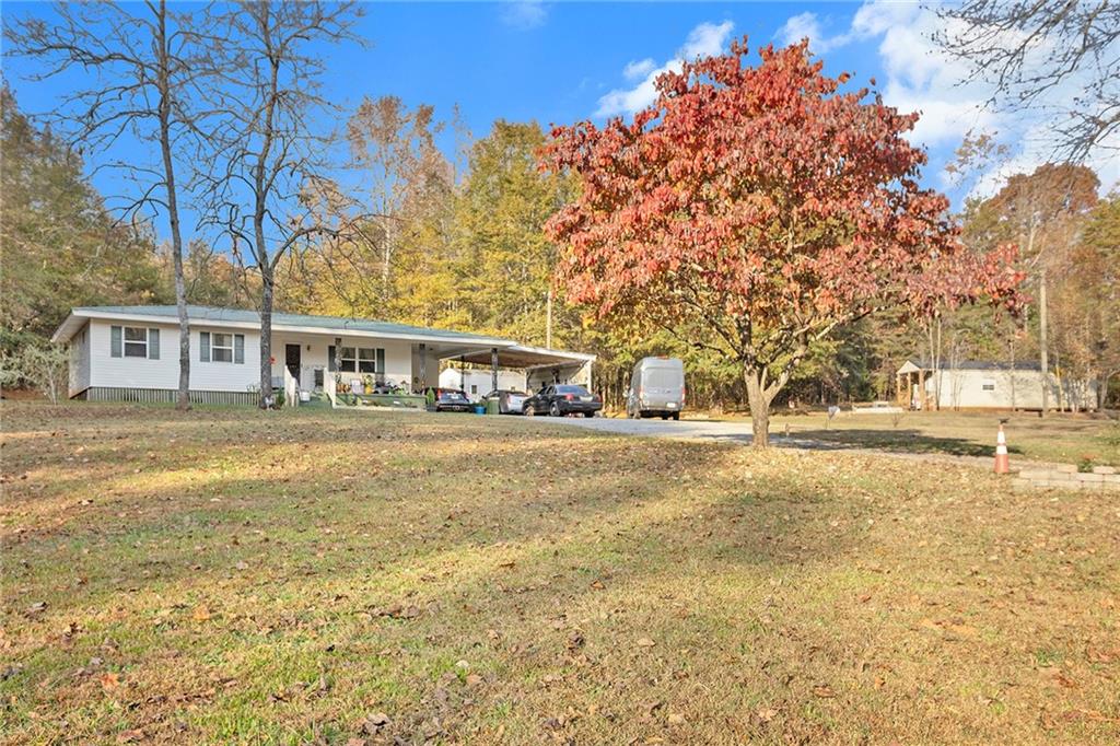 1246 Duncan Bridge Road Cornelia, GA 30531 - Photo 19 of 21 a house with trees in front of it