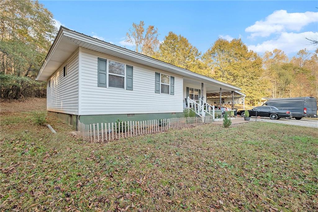 1246 Duncan Bridge Road Cornelia, GA 30531 - Photo 20 of 21 a front view of a house with a garden