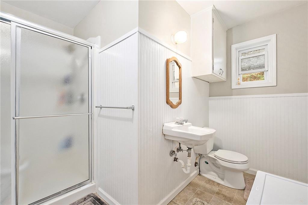 1246 Duncan Bridge Road Cornelia, GA 30531 - Photo 5 of 21 a bathroom with a toilet a sink and a mirror