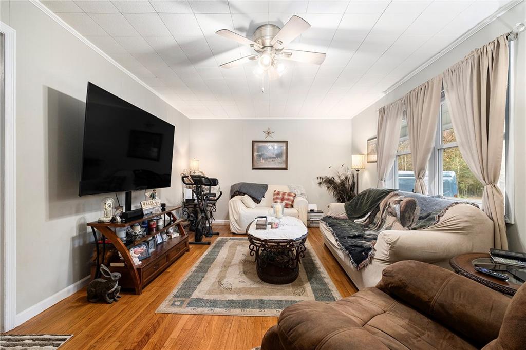 1246 Duncan Bridge Road Cornelia, GA 30531 - Photo 6 of 21 a living room with furniture and a flat screen tv