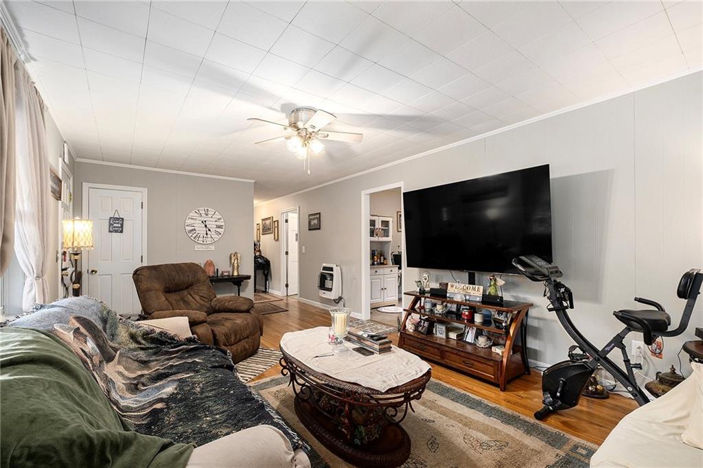 1246 Duncan Bridge Road Cornelia, GA 30531 - Photo 7 of 21 a living room with furniture and a flat screen tv