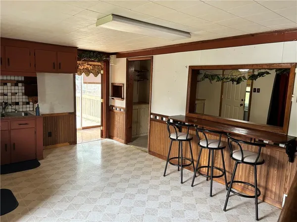 a view of kitchen with furniture and a refrigerator