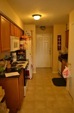 a kitchen with a sink appliances and cabinets