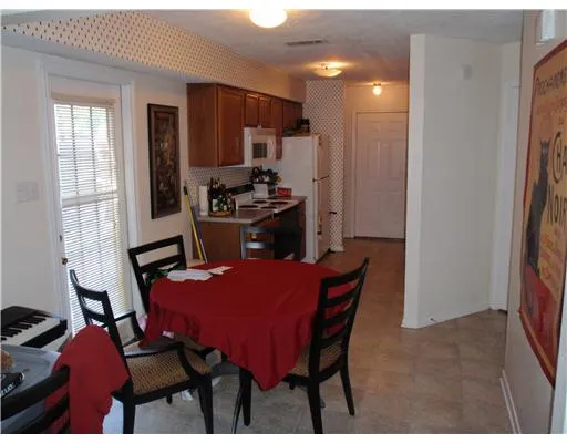 a dining room with furniture and window