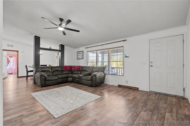 a living room with a fireplace and a flat screen tv