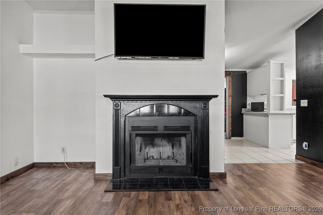26261 Beaver Run Wagram, NC 28396 - Photo 18 of 50 a living room with a fireplace and a flat screen tv
