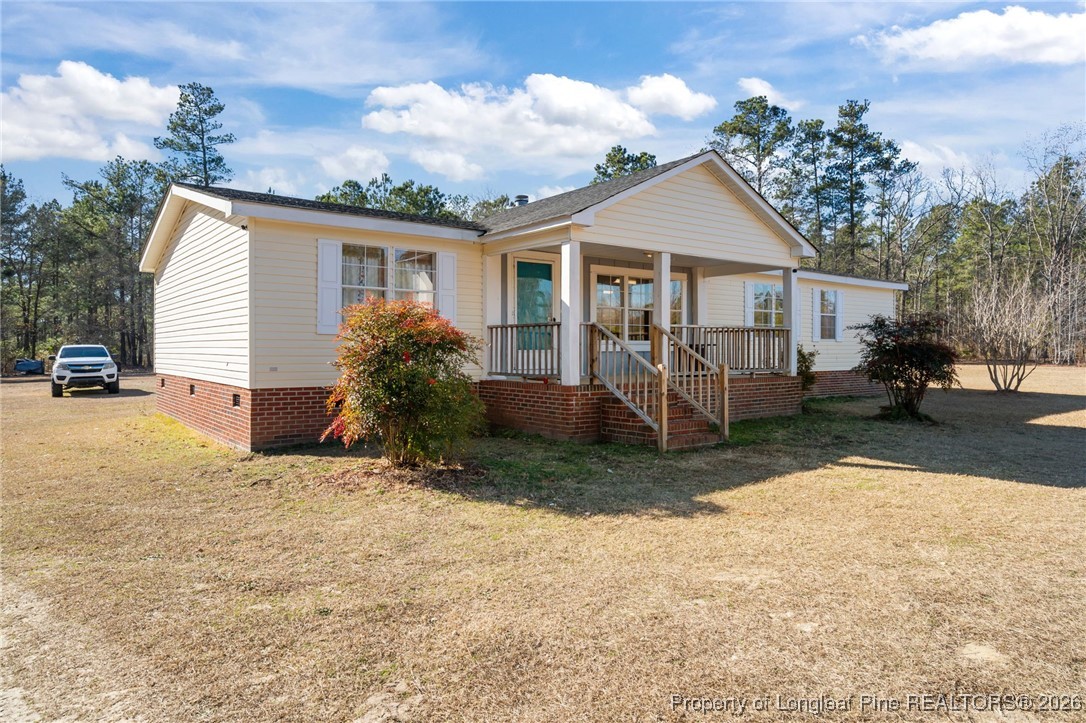 26261 Beaver Run Wagram, NC 28396 - Photo 2 of 50 a view of a house with a yard and large tree