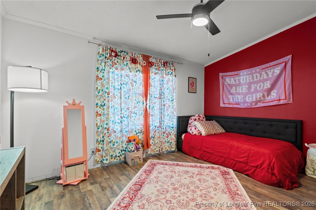 26261 Beaver Run Wagram, NC 28396 - Photo 23 of 50 a bedroom with a large bed and a chandelier