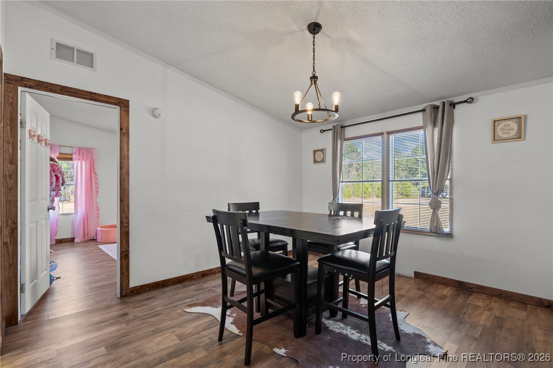 26261 Beaver Run Wagram, NC 28396 - Photo 25 of 50 a view of a dining room with furniture window and wooden floor