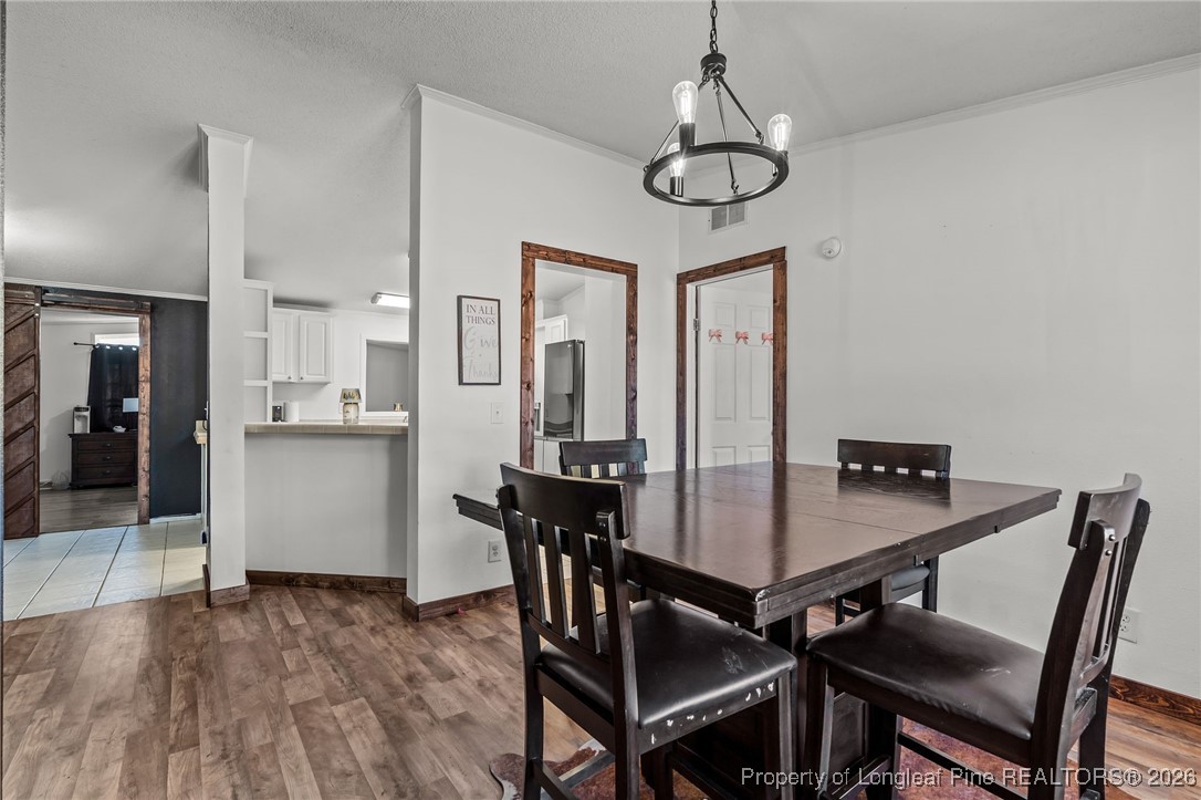 26261 Beaver Run Wagram, NC 28396 - Photo 27 of 50 a view of a dining room with furniture window and wooden floor