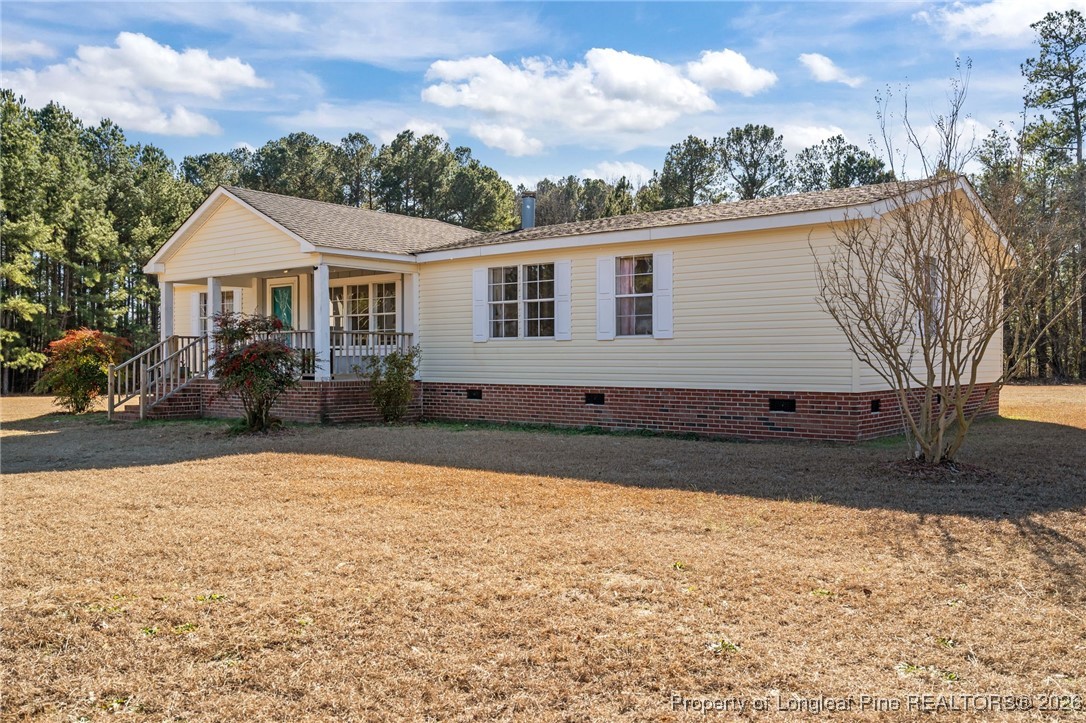 26261 Beaver Run Wagram, NC 28396 - Photo 3 of 50 a front view of a house with a yard