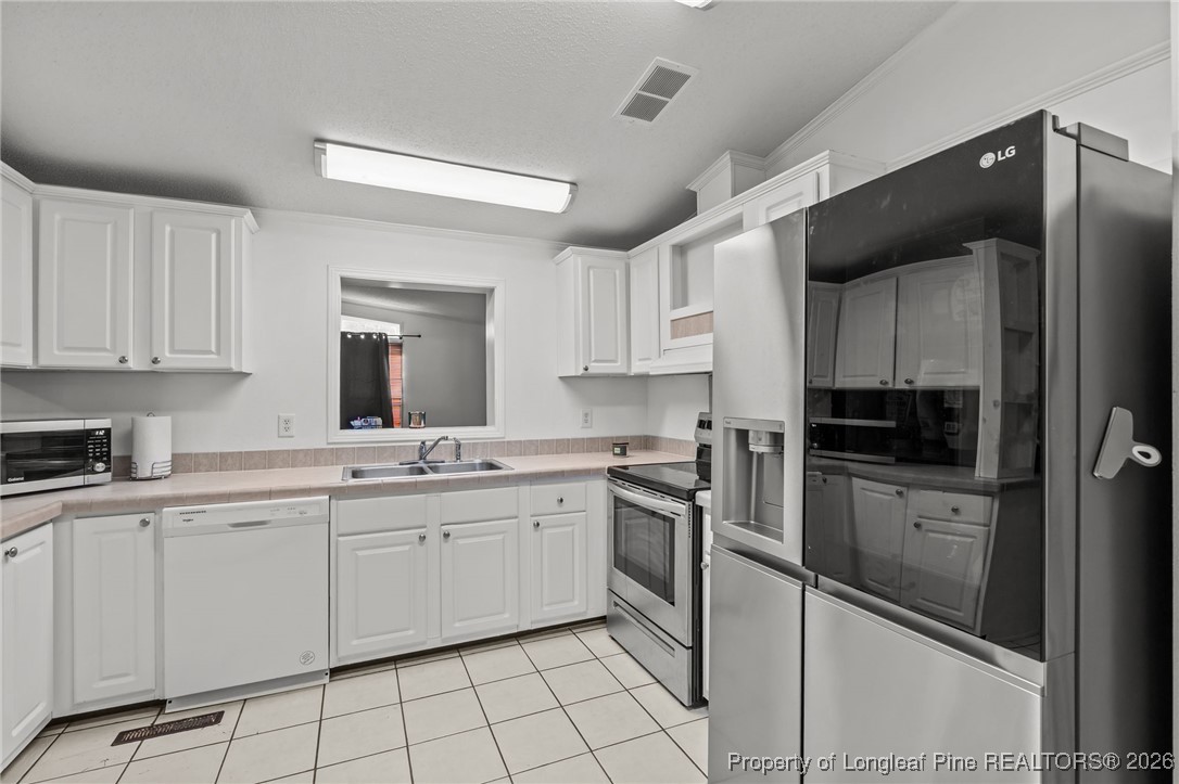 26261 Beaver Run Wagram, NC 28396 - Photo 32 of 50 a kitchen with a sink cabinets and stainless steel appliances