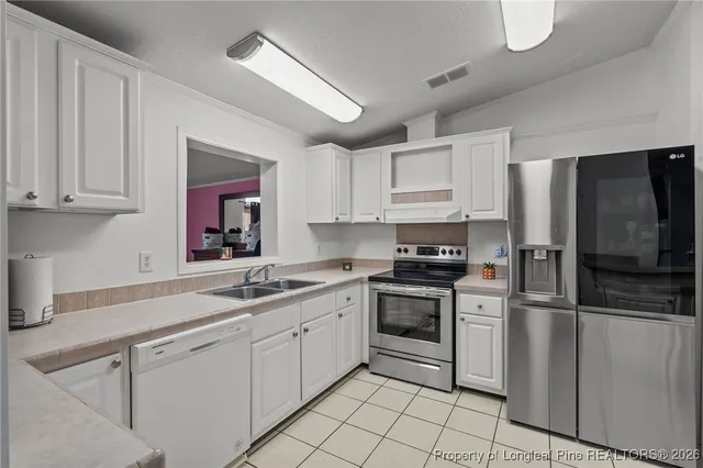 a kitchen with cabinets and stainless steel appliances
