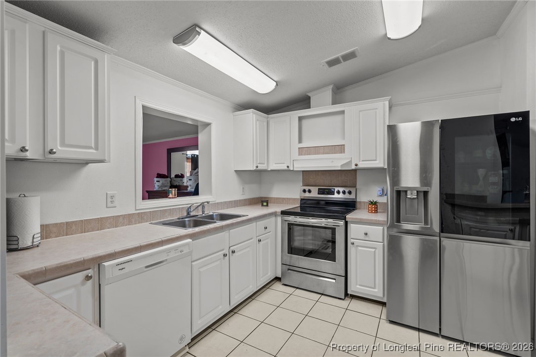 26261 Beaver Run Wagram, NC 28396 - Photo 33 of 50 a kitchen with stainless steel appliances granite countertop a sink and cabinets