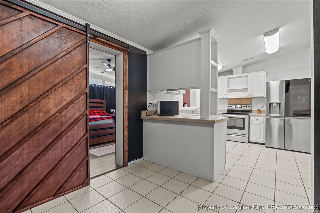 26261 Beaver Run Wagram, NC 28396 - Photo 35 of 50 a kitchen with cabinets and stainless steel appliances