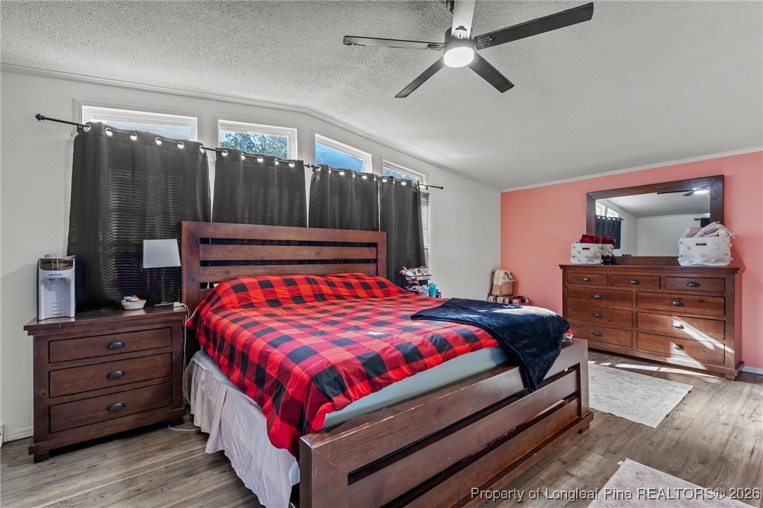 26261 Beaver Run Wagram, NC 28396 - Photo 36 of 50 a bedroom with a bed and a dresser