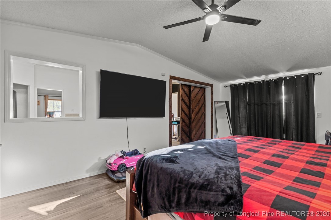 26261 Beaver Run Wagram, NC 28396 - Photo 37 of 50 a bedroom with a bed and a flat screen tv