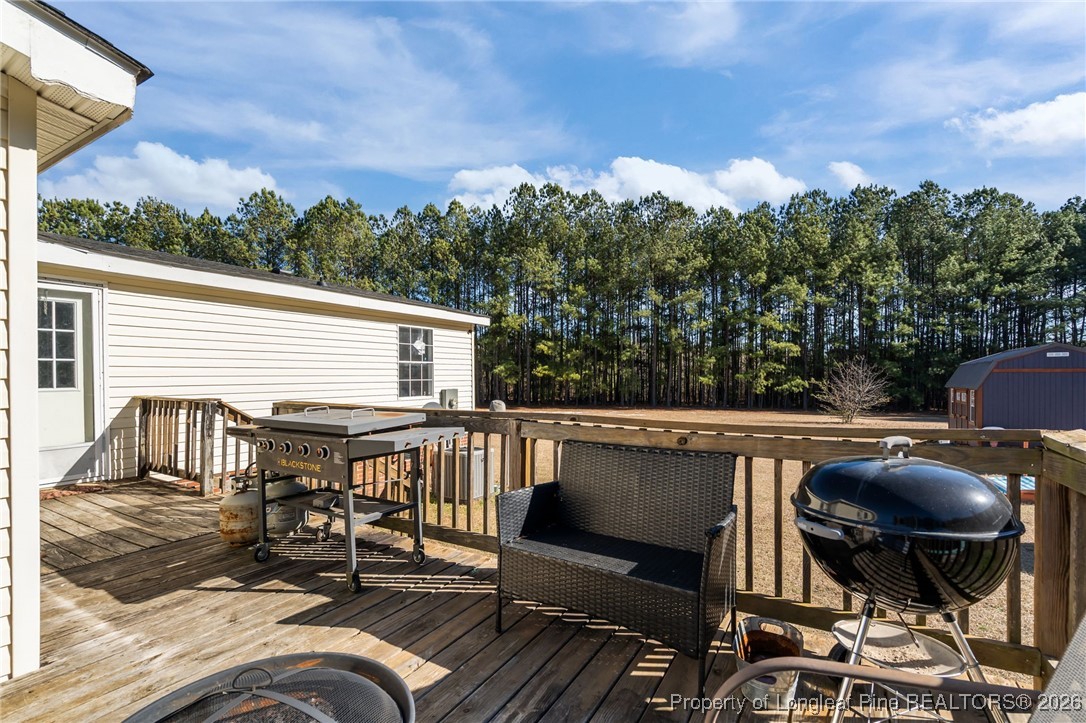 26261 Beaver Run Wagram, NC 28396 - Photo 49 of 50 a view of balcony with wooden floor and outdoor seating
