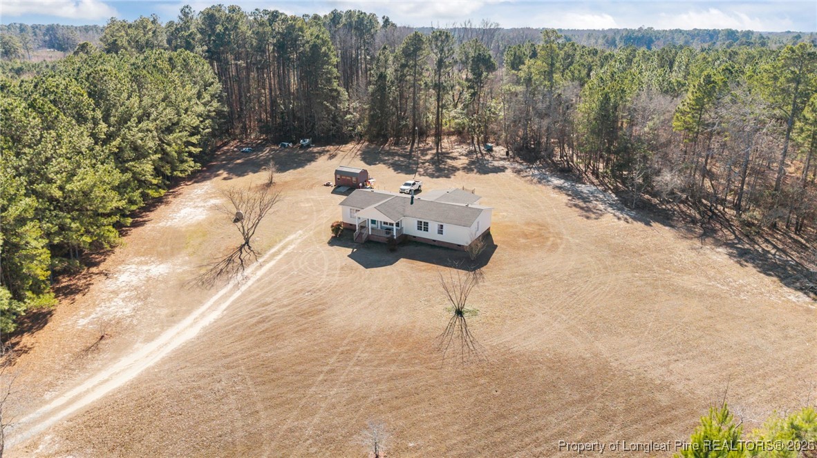 26261 Beaver Run Wagram, NC 28396 - Photo 5 of 50 a view of a backyard with table and chairs