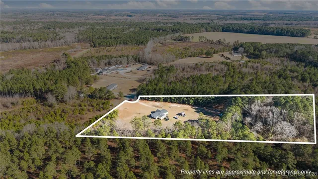 an aerial view of a house with outdoor space