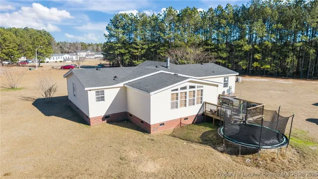 an aerial view of a house with table and chairs